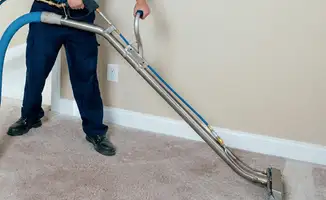 Professional operating a liquid removal machine on a carpeted floor in Hollywood, FL